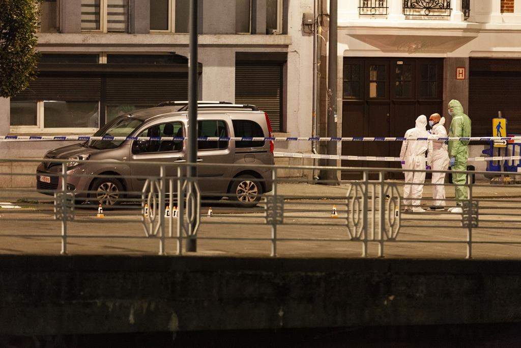 Police and inspectors work in an area where a shooting took place in the center of Brussels, Monday, Oct. 16, 2023. Belgian police say that two people are dead in central Brussels after several shots were fired. (AP Photo/Nicolas Landemard)