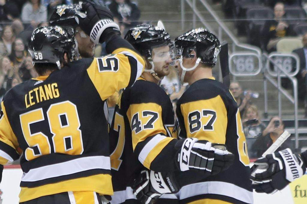 Pittsburgh Penguins’ Adam Johnson (47) celebrates with Sidney Crosby (87) and Kris Letang (58) after scoring against the Columbus Blue Jackets during the second period of an NHL preseason hockey game, Saturday, Sept. 22, 2018, in Pittsburgh. Members of the Winnipeg Jets expressed their support for Adam Johnson, a former NHL player who suffered a serious injury while playing professionally in England on Saturday, leading to the game being abandoned.