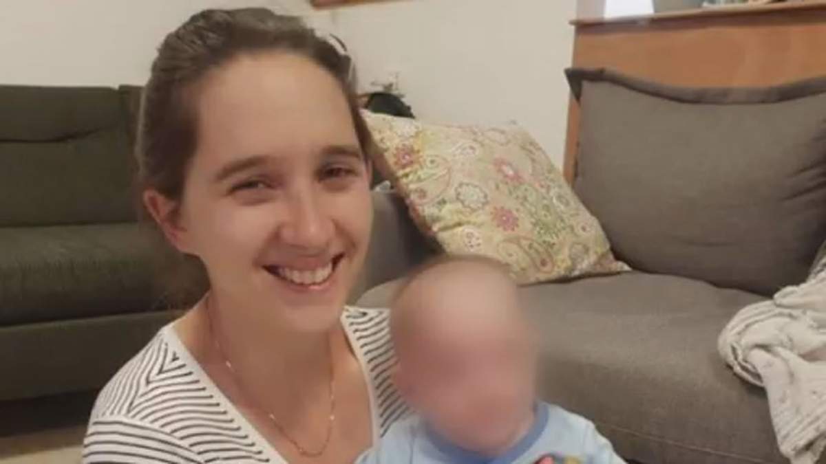 Adi Vital-Kaploun, a Canadian citizen killed in Israel, smiles at the camera while holding a baby