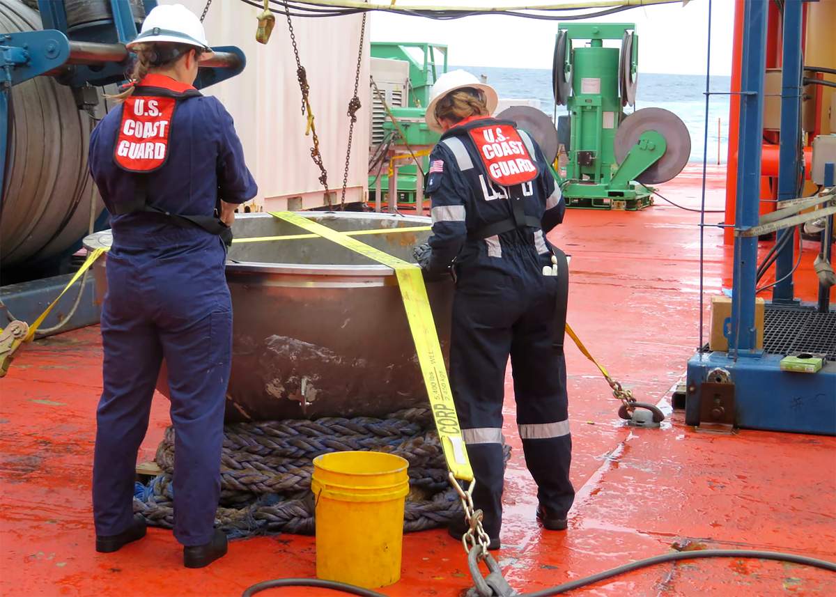 U.S. Coast Guard marine safety engineers conduct a survey of the aft titanium endcap from the Titan submersible, in the North Atlantic Ocean, Sunday, Oct. 1, 2023. The endcap was recently recovered from the seafloor and successfully transferred to a U.S. port for analysis.
