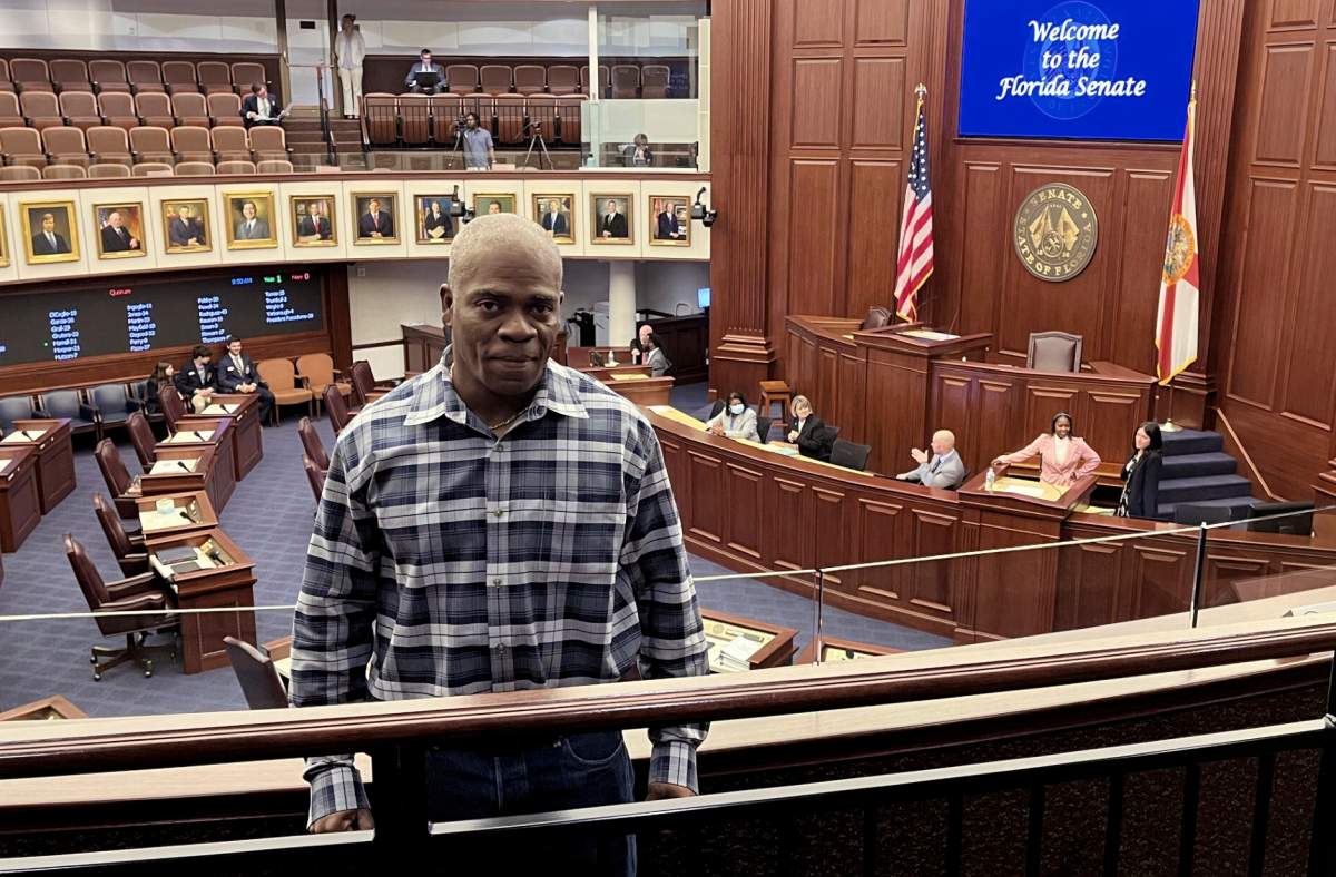 In this photo provided by the Innocence Project of Florida, Leonard Allen Cure poses from the floor of the Florida legislature in Tallahassee, Fla., in April 2023, on the day his compensation bill was passed.