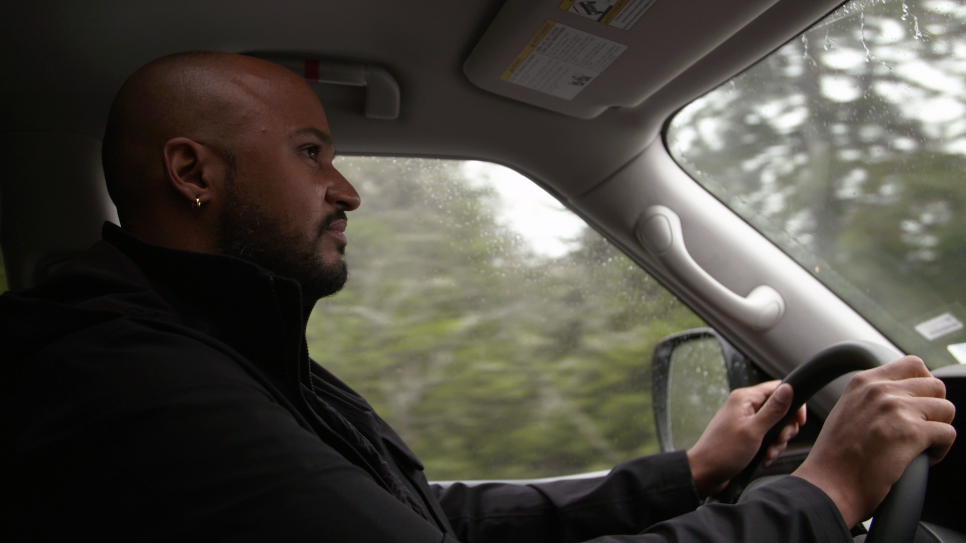 Curtis Whiley drives along Pockwock Road in Upper Hammonds Plains. On either side of the road, new housing projects are being built. Whiley welcomes new housing in the area but says community members have been left in the dark. Often, all the units are sold before local African Nova Scotians find out about them, he says.