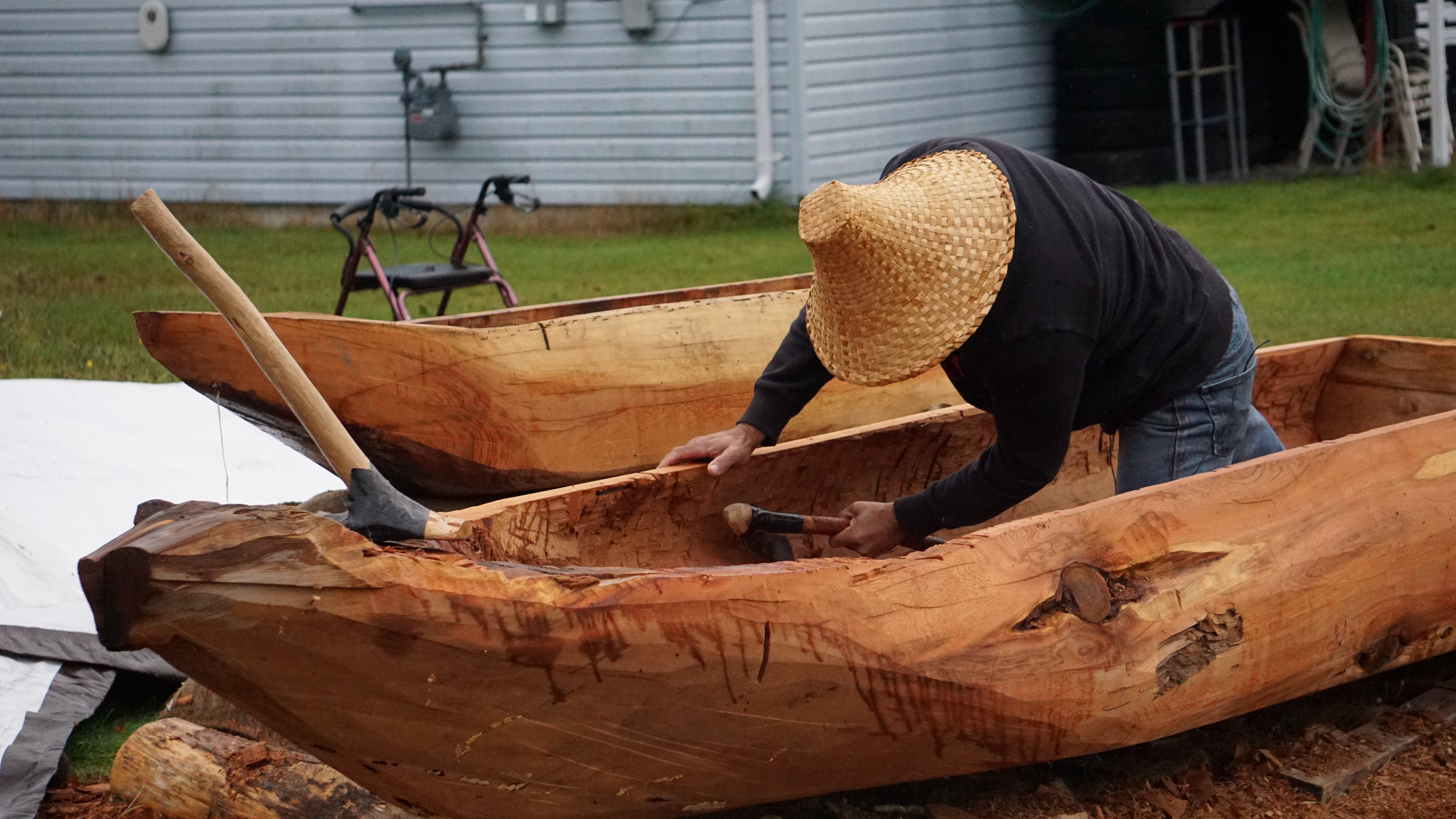 The Haisla Nation's Tom Cordeiro works on his 12-foot-long practice 'skinoe' at home in Kitamaat Village on Sun. Oct. 1, 2023.