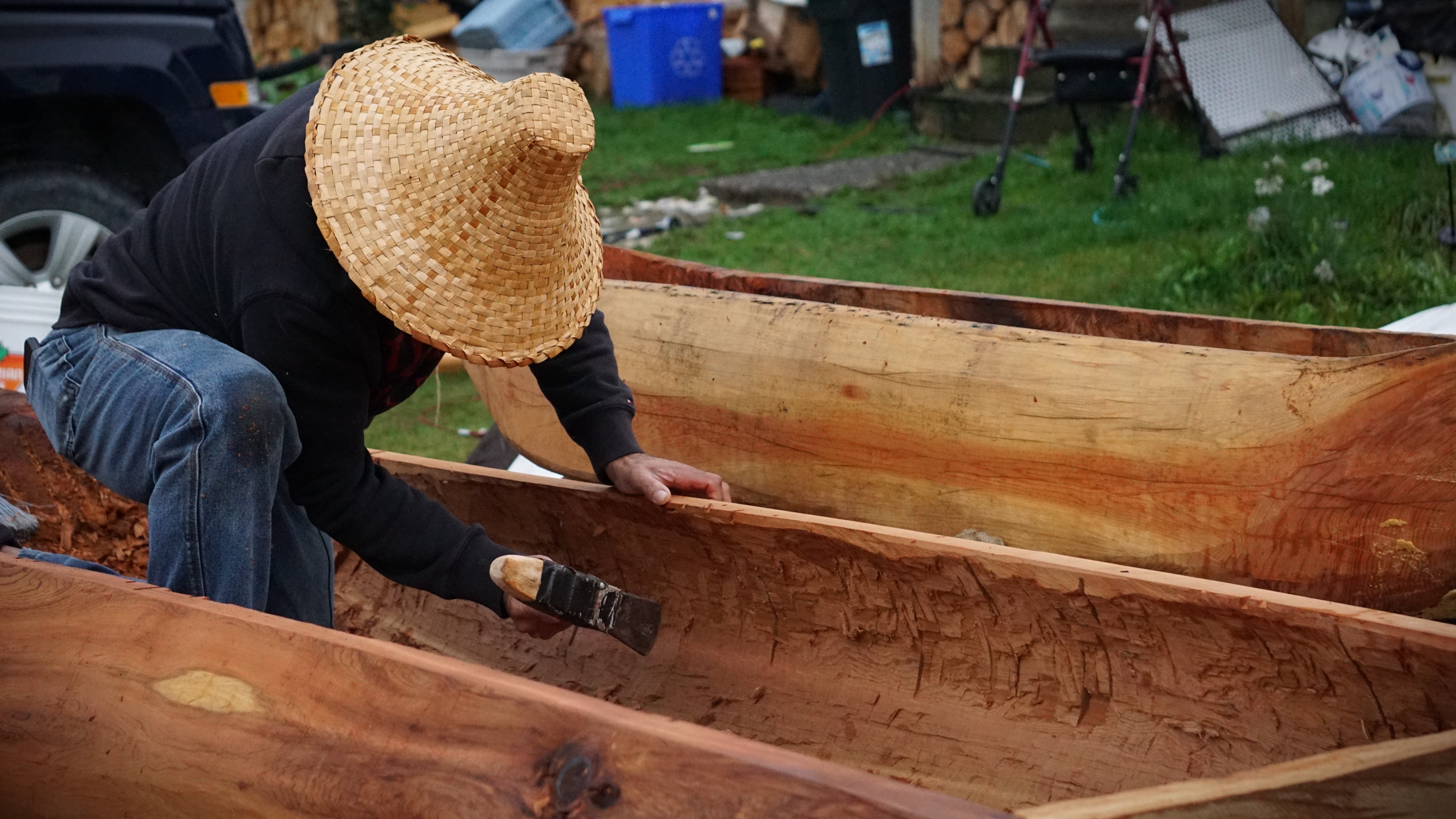 Tom Cordeiro chips away at his cedar canoe in Kitimaat Village on Sun. Oct. 1, 2023.