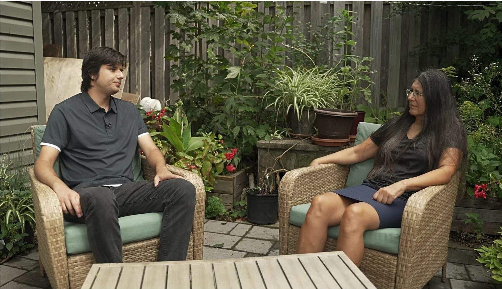 Deborah McGregor speaks with her son, Hillary, in their backyard