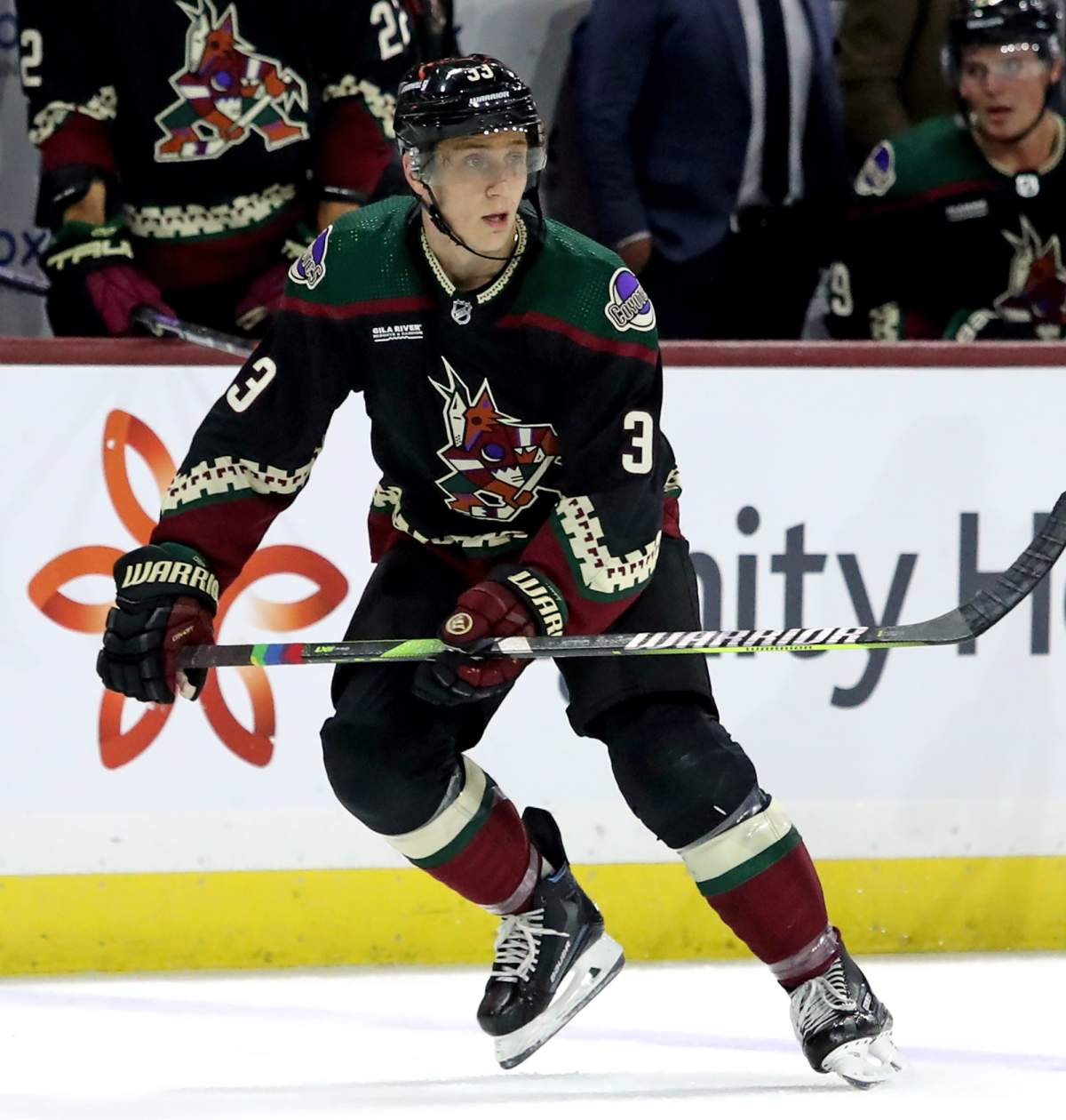 Travis Dermott #33 of the Arizona Coyotes skates on the ice with pride tape at Mullett Arena on October 21, 2023 in Tempe, Arizona.