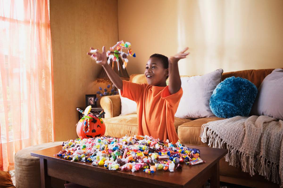 boy sorts halloween candy