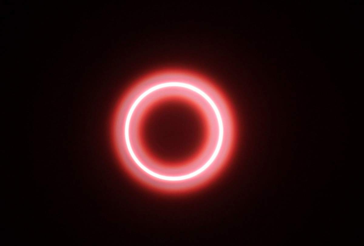 An annular solar eclipse is seen though safety glass in Indonesia, in 2019.