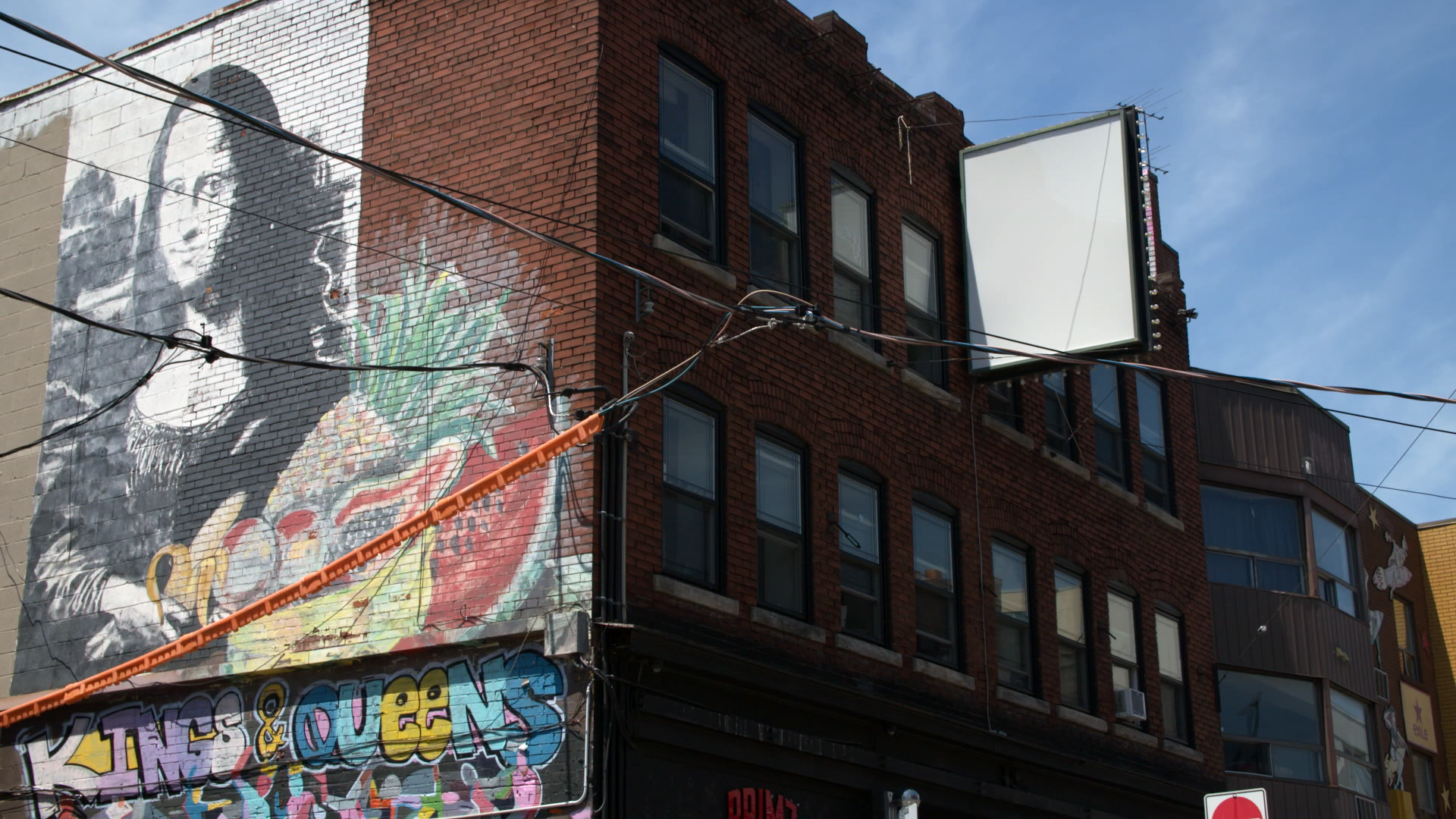 The “Mona Lisa Building” at the corner of Kensington Ave and St. Andrew Street was the Kensington Market CLT’s first purchase. It contains 12 residential units and five local businesses.
