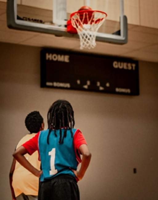 Children play basketball in a local community centre. Popalzai worked within the community to encourage the kids of Regent to return to the courts.