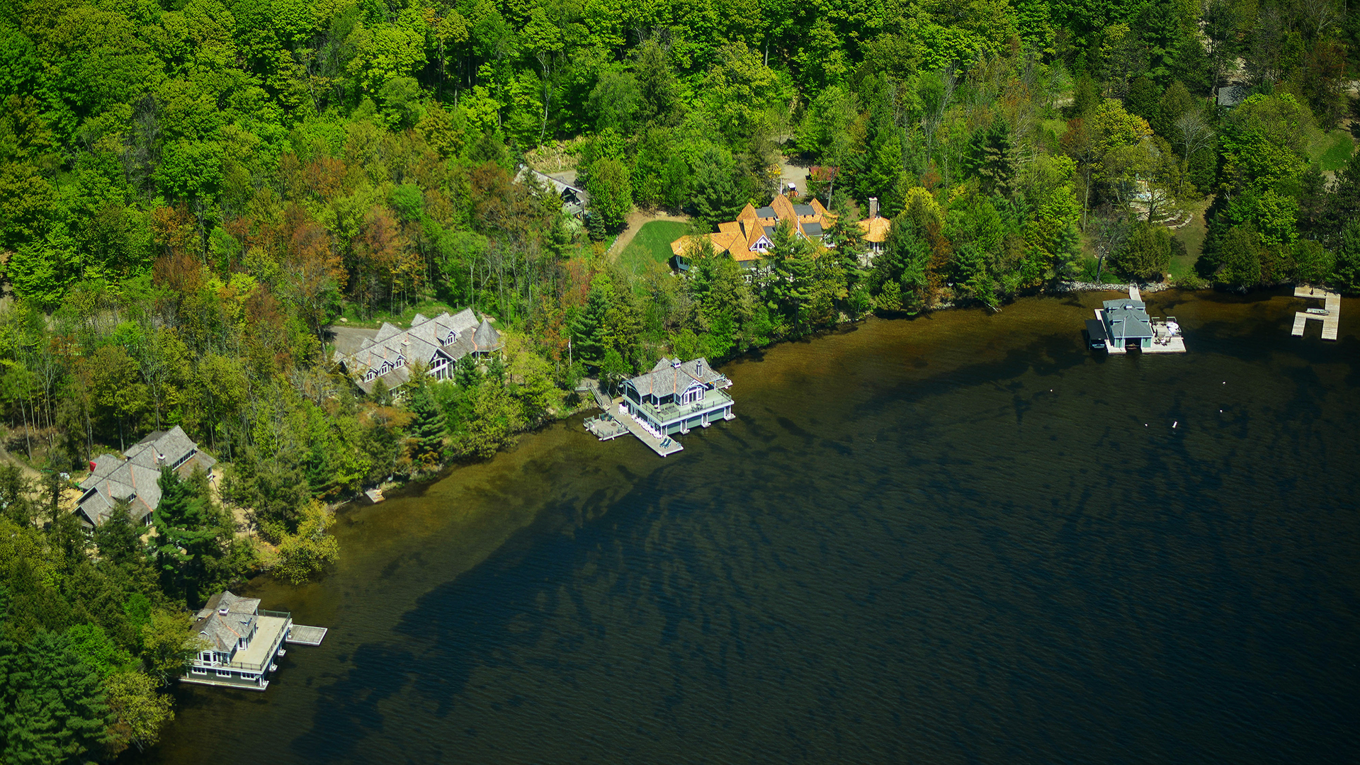 Cottages line the shores of the Muskoka lakes in this aerial photograph taken above Muskoka, Ontario, Canada, on May 23, 2015.
