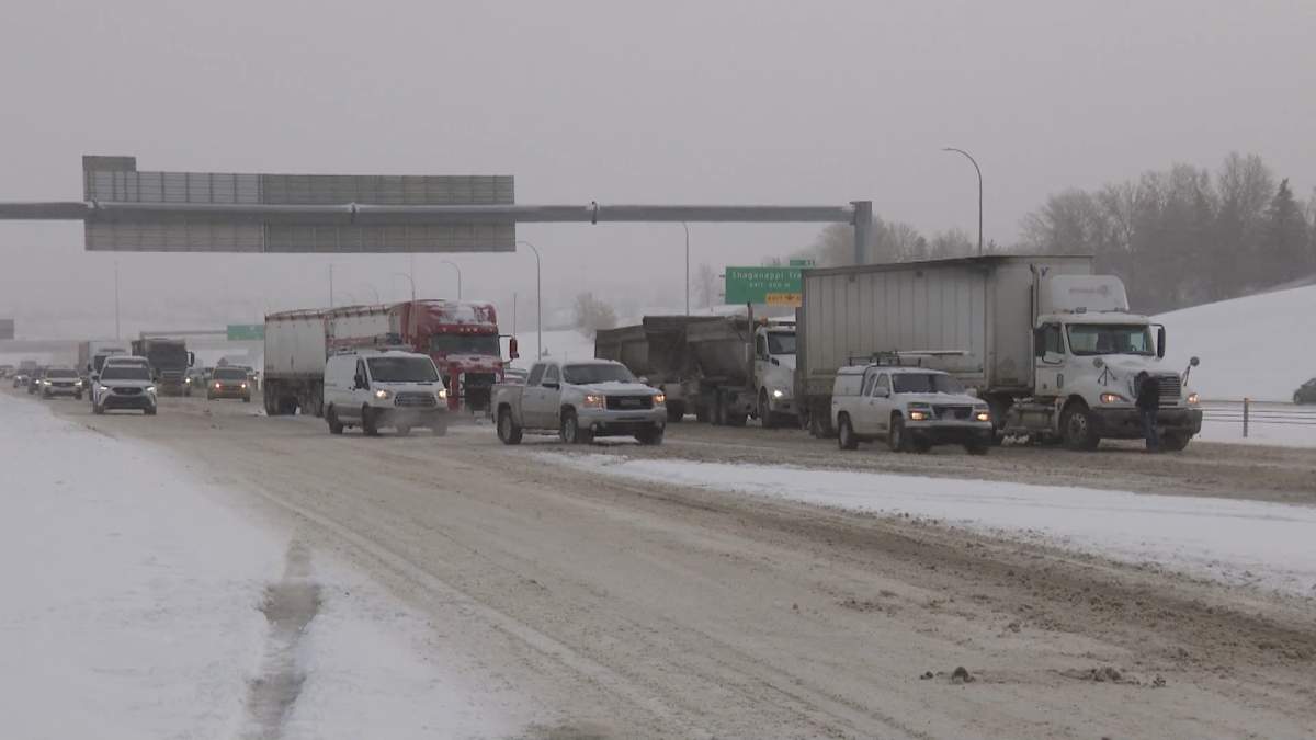 Drivers make their way around stalled semi trucks on Stoney Trail in Calgary on Oct. 24, 2023.