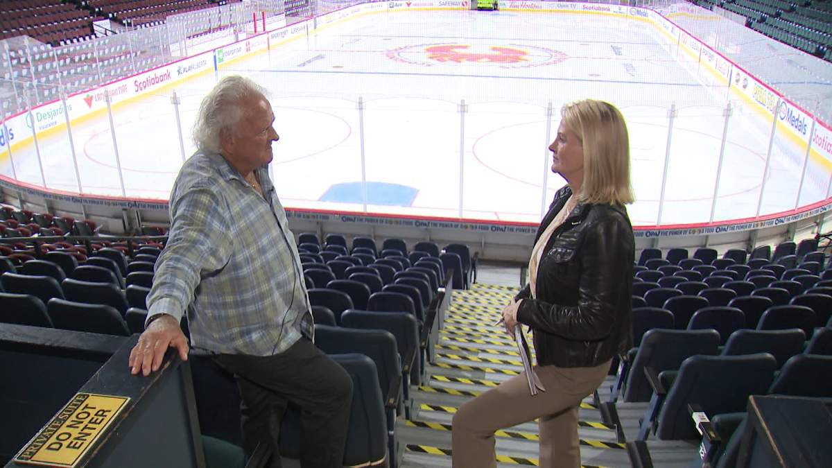 Art Froese, who was president of the Olympic Coliseum Society, and Global News anchor Linda Olson stand in an area of the Saddledome that was underwater during the floods of 2013.