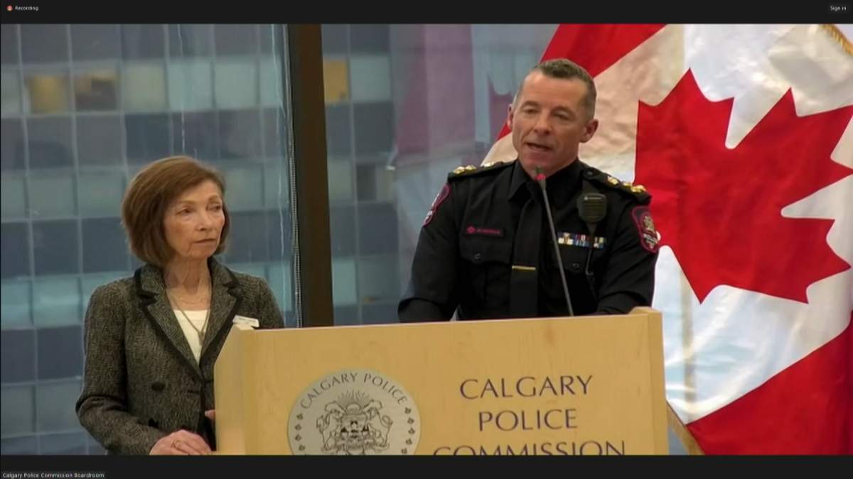 Calgary Police Commission chair Shawn Cornett (L) looks on as Calgary police Chief Mark Neufeld speaks at a commission meeting on Oct. 25, 2023.