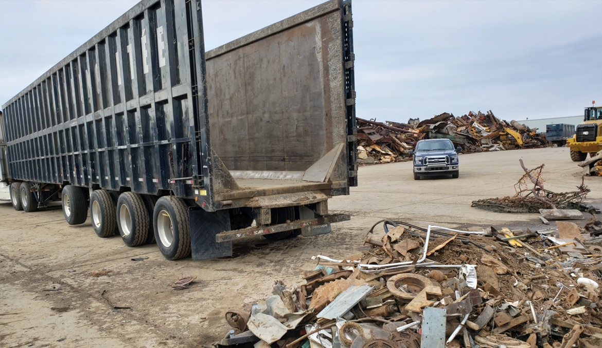 The operator clears the scrap from the front to back and the driver is responsible for opening the back of trailer.
