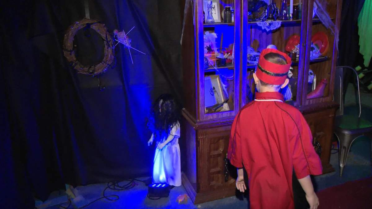 Corrie J.’s son helps lead the family time tour at Theatre of Madness.