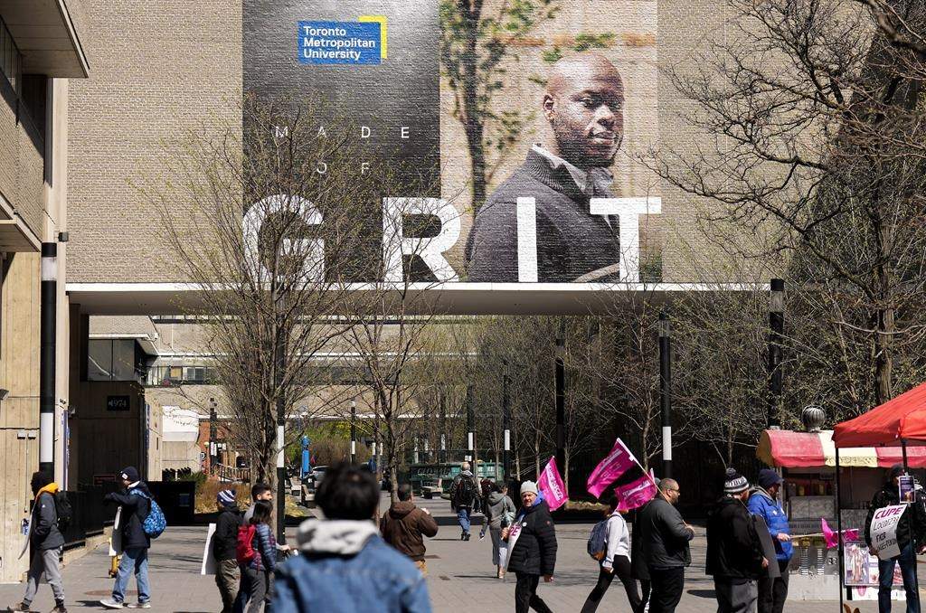 A government-commissioned report on the finances of Ontario's universities and colleges says the province should both end its tuition freeze and increase per-student funding to those institutions. Students make their way around the renamed Toronto Metropolitan University (TMU), formerly known as Ryerson University in Toronto on Wednesday, April 26, 2023. 