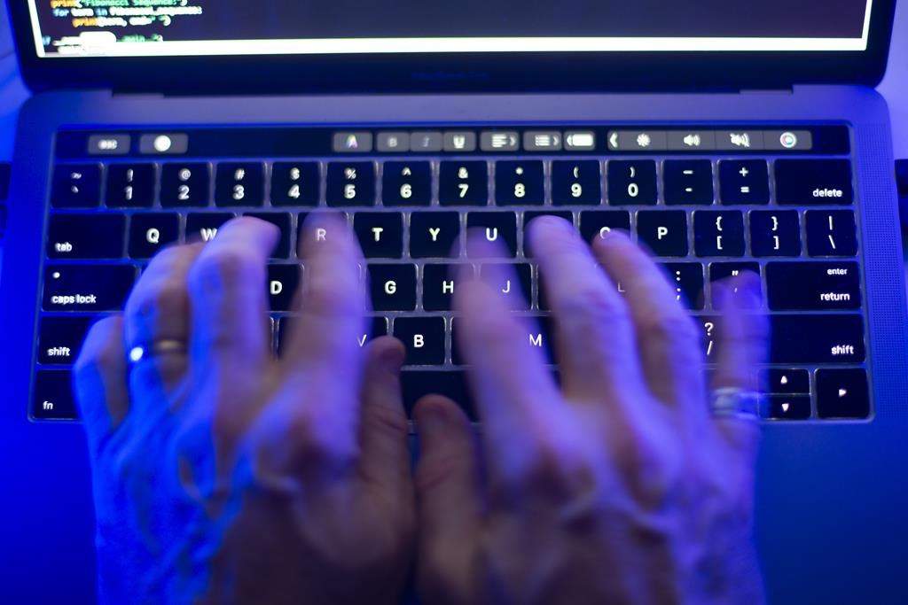 Toronto Public Library says employee information dating back more than 20 years has likely been taken in a cyberattack, including social insurance numbers and copies of government-issued identification. A man uses a computer keyboard in Toronto, Monday, Oct. 9, 2023 in this photo illustration. THE CANADIAN PRESS/Graeme Roy.