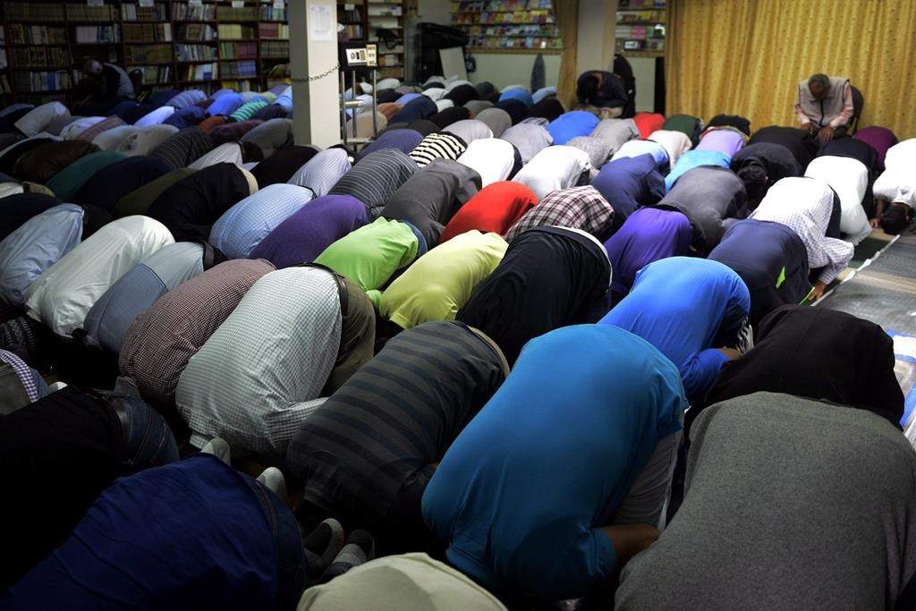 After a man allegedly called a group of Muslims "terrorists" before nearly striking them with a boulder outside a Toronto area mosque where kids and adults were gathered to pray, a rabbi sent a message to the worshippers to express sympathy. People attend prayers at the Toronto Islamic Centre on Friday, Sept. 25, 2015. THE CANADIAN PRESS/Marta Iwanek.