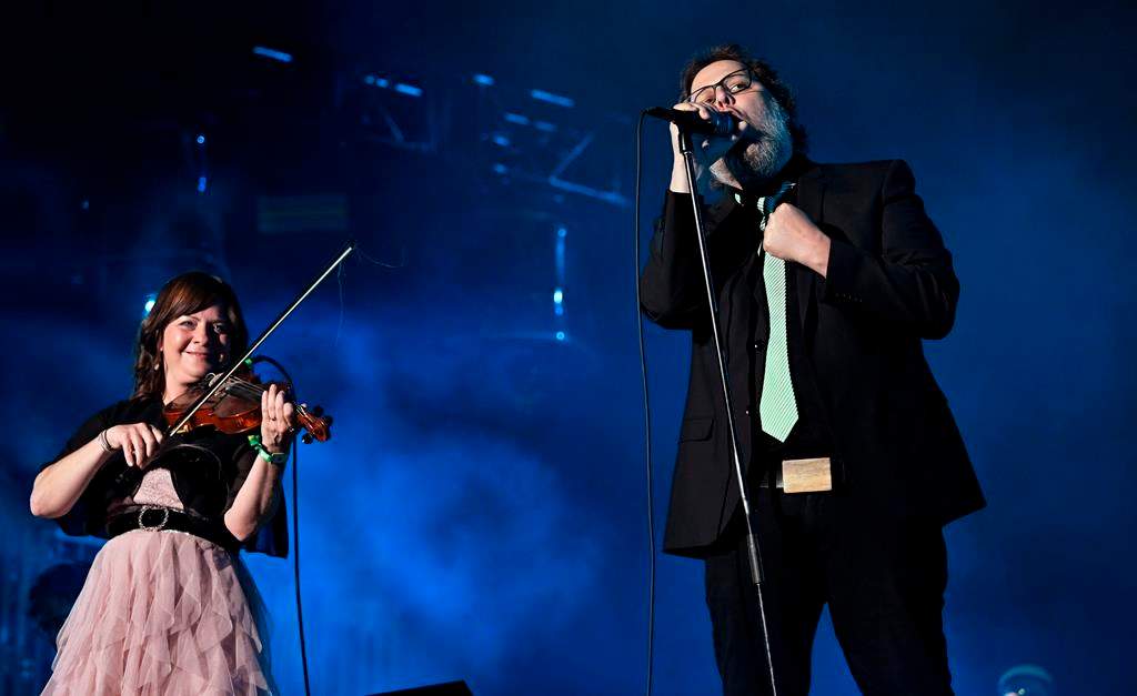 Quebecers will get a chance to say goodbye to beloved folk-rock group 'Les Cowboys Fringants' lead singer Karl Tremblay during a funeral next week in Montreal. Tremblay, right, sings as his wife Marie-Annick Lépine plays the violin during their performance at the Quebec Summer Festival, in Quebec City, Monday, July 17, 2023. 