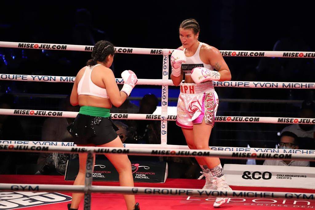 Jeanette Guadeloupe Zacarias Zapata (left) faces Marie-Pier Houle in a welterweight fight at the stade IGA, Montréal, Saturday, Aug. 28, 2021. A Quebec coroner says Mexican boxer Zapata did not disclose a likely prior concussion before the August 2021 match in Montreal that led to her death. 