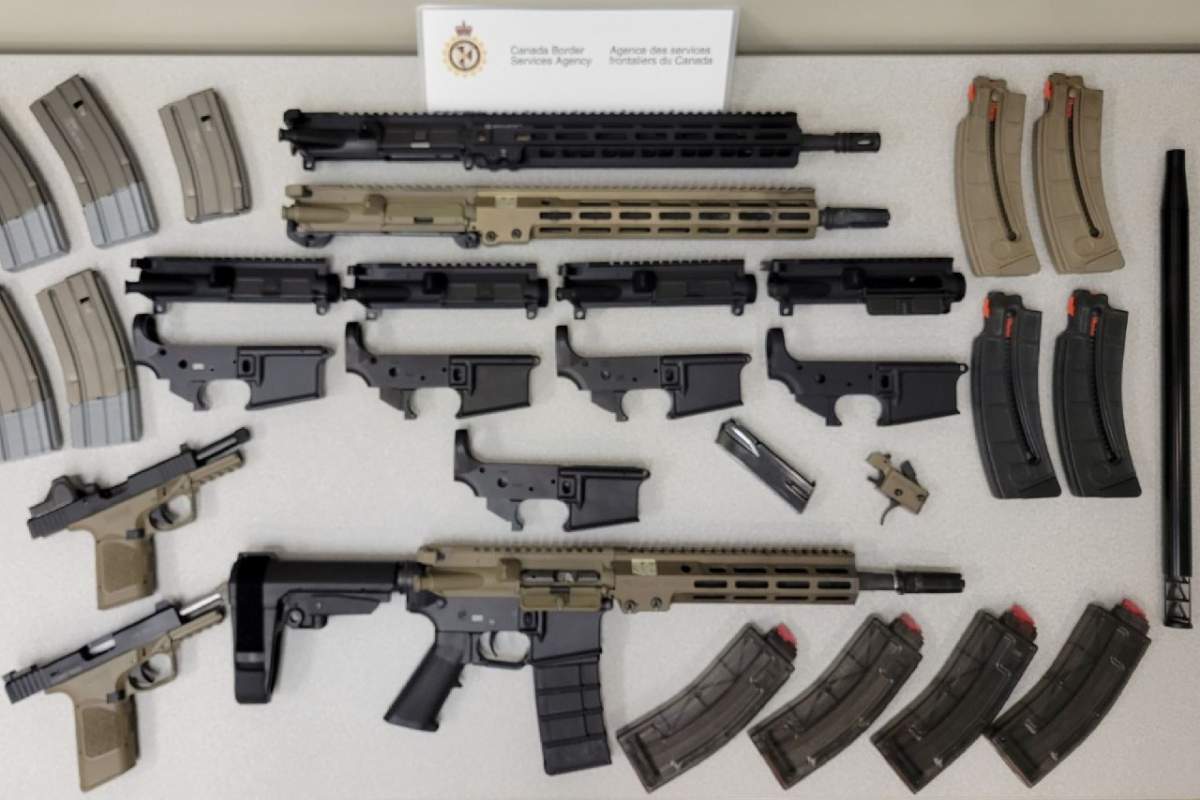 Firearms and magazines seized in October 2023 during the execution of a search warrant by the CBSA’s Ontario Firearms Smuggling Enforcement Team are displayed in this handout photo.