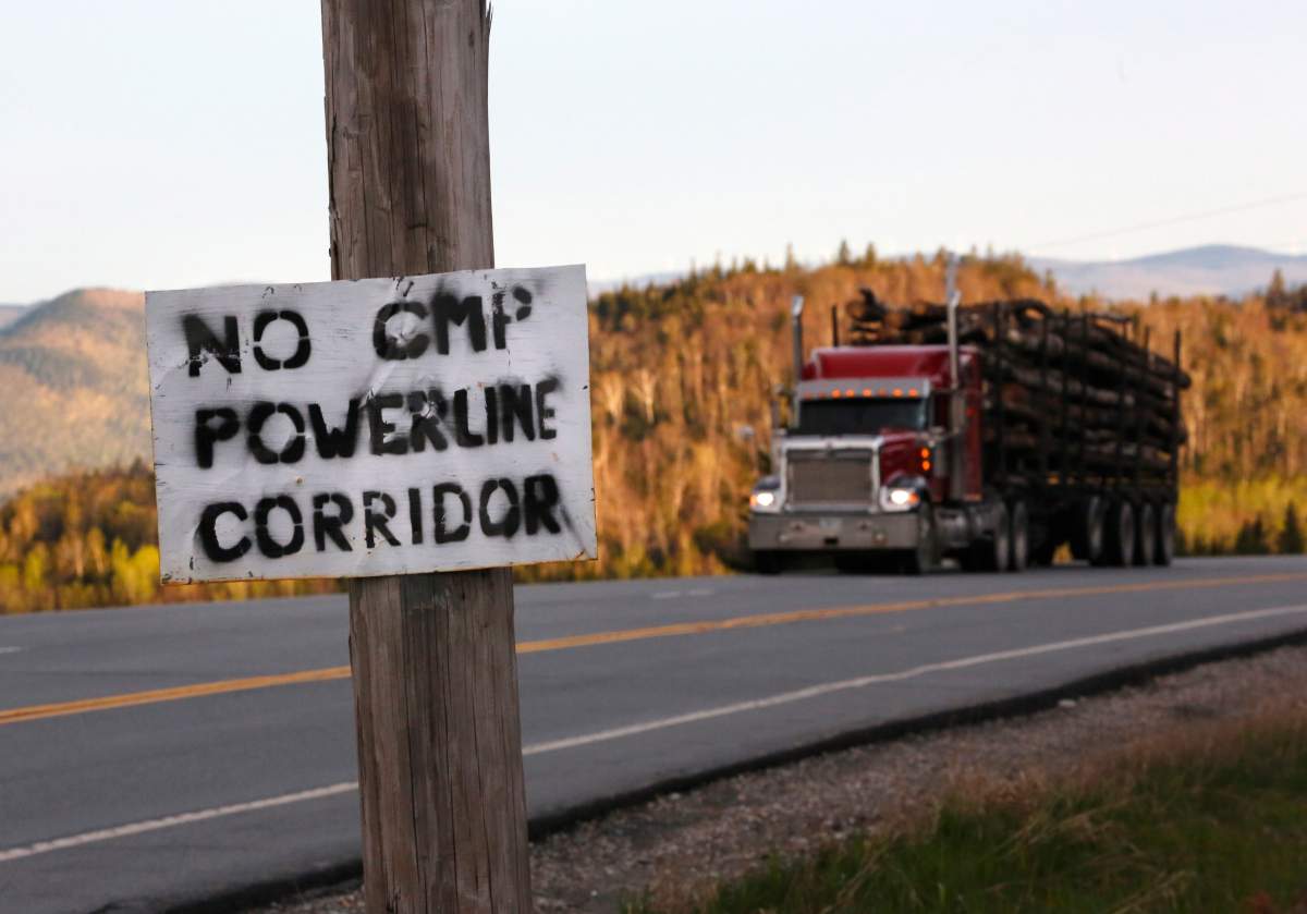 FILE – In this Tuesday, May 28, 2019, file photo, a homemade sign is posted on a telephone pole in protest of Central Maine Power’s controversial hydropower transmission corridor in Jackman, Maine. A $1 billion hydropower electricity transmission corridor called the New England Clean Energy Connect would cut through sparsely populated woodlands. Environmental groups disagree about whether the 145-mile corridor comes at too high a cost in loss of trees and wildlife habitat. (AP Photo/Robert F. Bukaty, File)