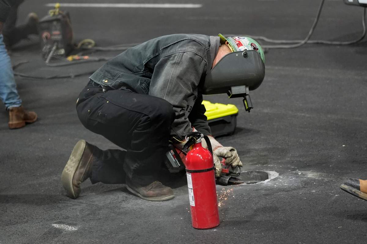 Work is performed on a manhole following the first practice session for the Formula 1 Las Vegas Grand Prix on Thursday night.
