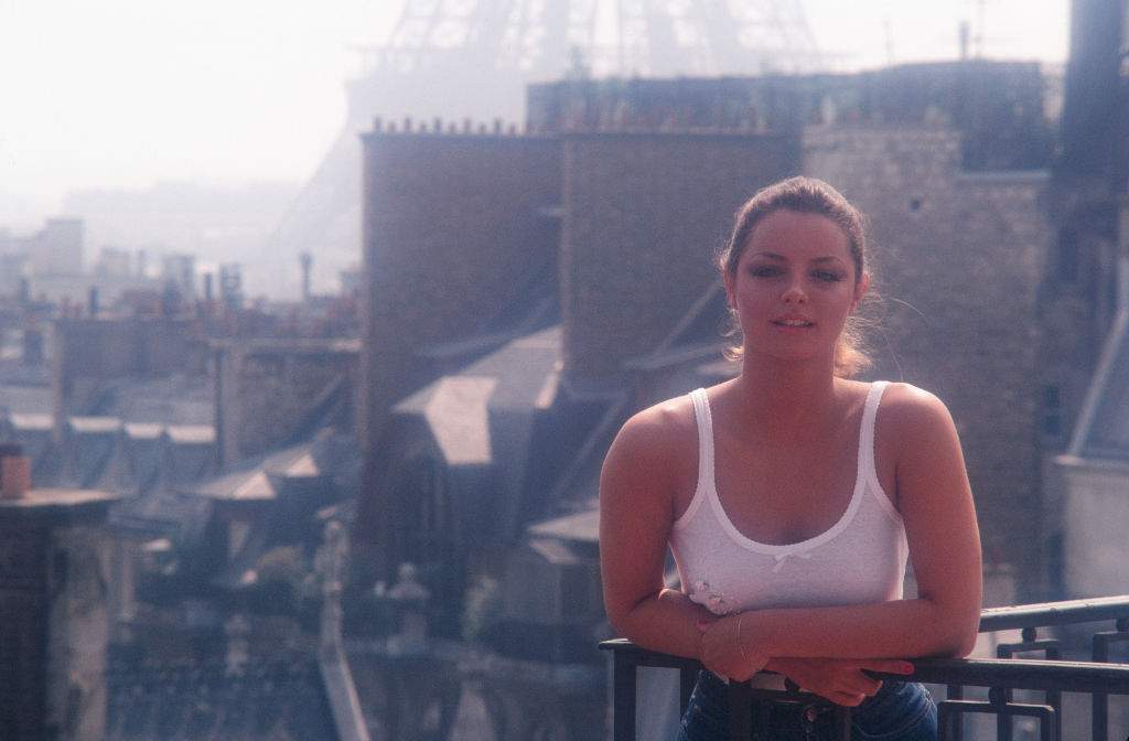 Portrait of American model and actress Sheila Kennedy as she leans on the balcony at the Four Seasons Hotel George V, Paris, France, August 1981. A photo from this session later appeared on the cover of the October 1987 issue of Penthouse magazine.