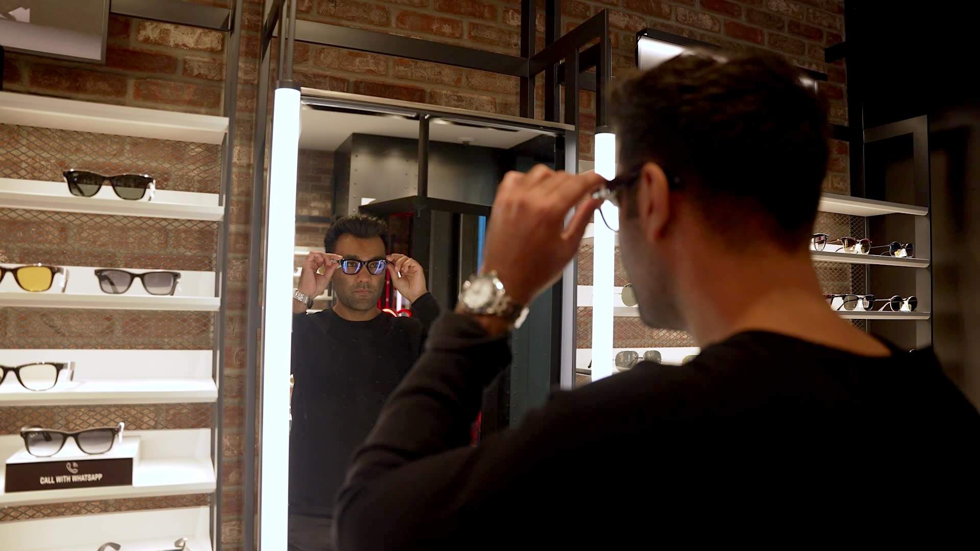 Hamayal Choudhry, founder and CEO of Canadian company smartARM, is trying on the new Ray-Ban AI glasses using Meta technology. He's got dark hair and is wearing a dark, long sleeved shirt. Choudhry happened to be in the store when the Global News team for The New Reality was testing out the demo models and they got to chatting.