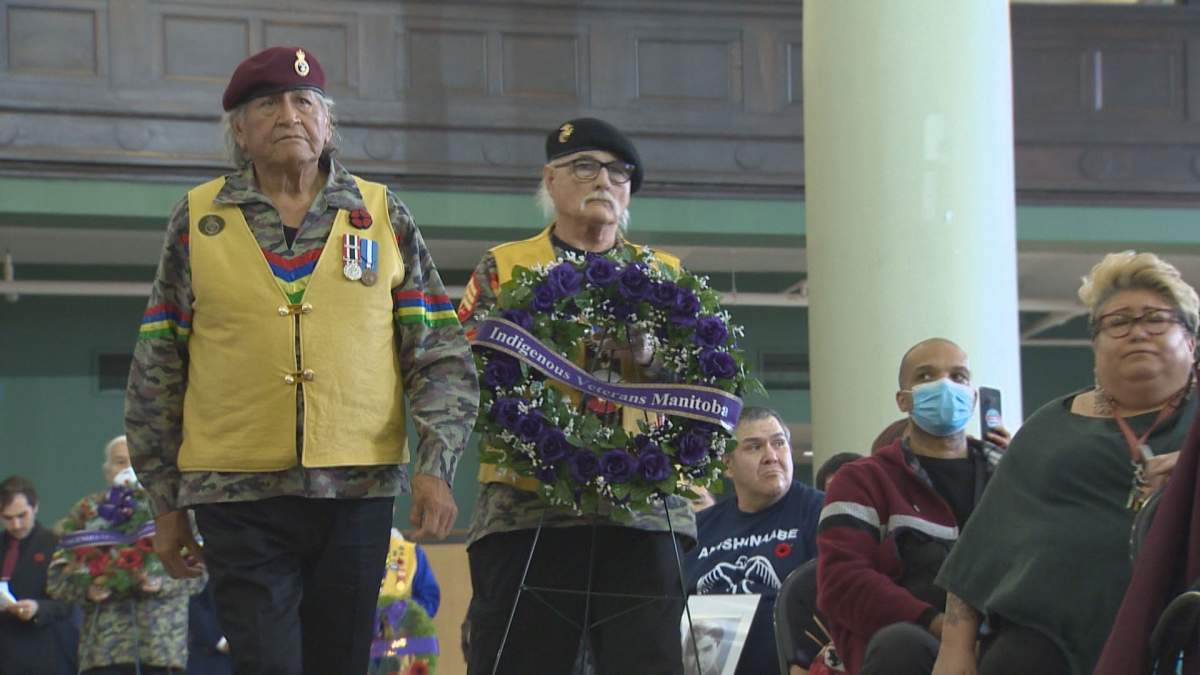 Elder and veteran Wandbi Wakita carries a wreath to lay at the Neeginan Centre on Indigenous Veterans Day.