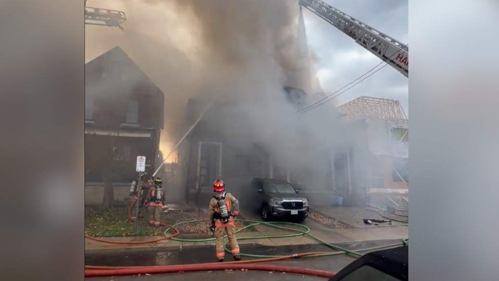 Firefighters battle a blaze in a residential neighbourhood at Melbourne Avenue and Dundurn Street in Hamilton, Ont.  