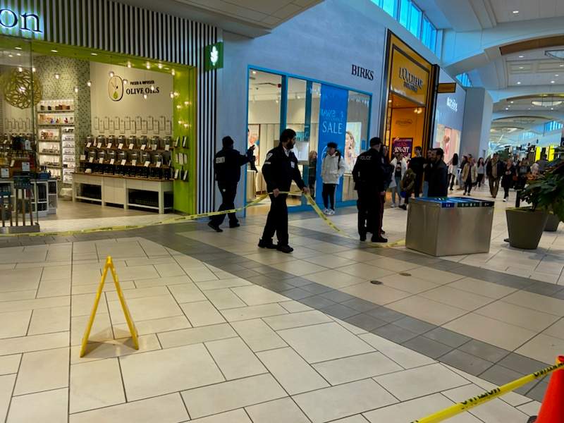 Police and security guards cordon off an area inside Market Mall after an assault with a weapon, on Nov. 24, 2023.
