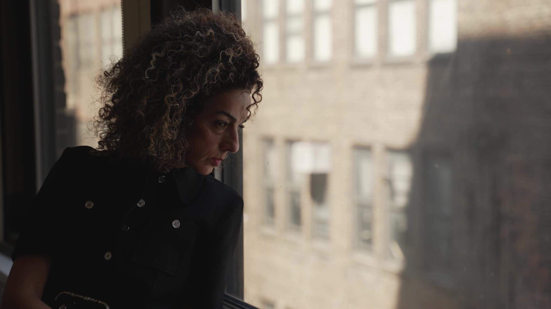 Masih Alinejad looks out the window from a secure location in New York City.