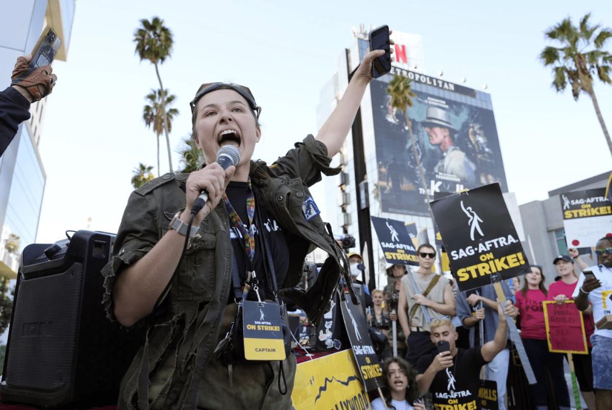 SAG-AFTRA captain Mary M. Flynn with a microphone.