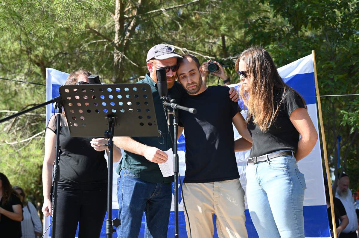 Vivian Silver's sons, Chen (left) and Yonatan Zeigen embrace at their mother's funeral in Gezer, Israel on November 16, 2023. They devilvered their mother's eulogy in Hebrew during the ceremony.
