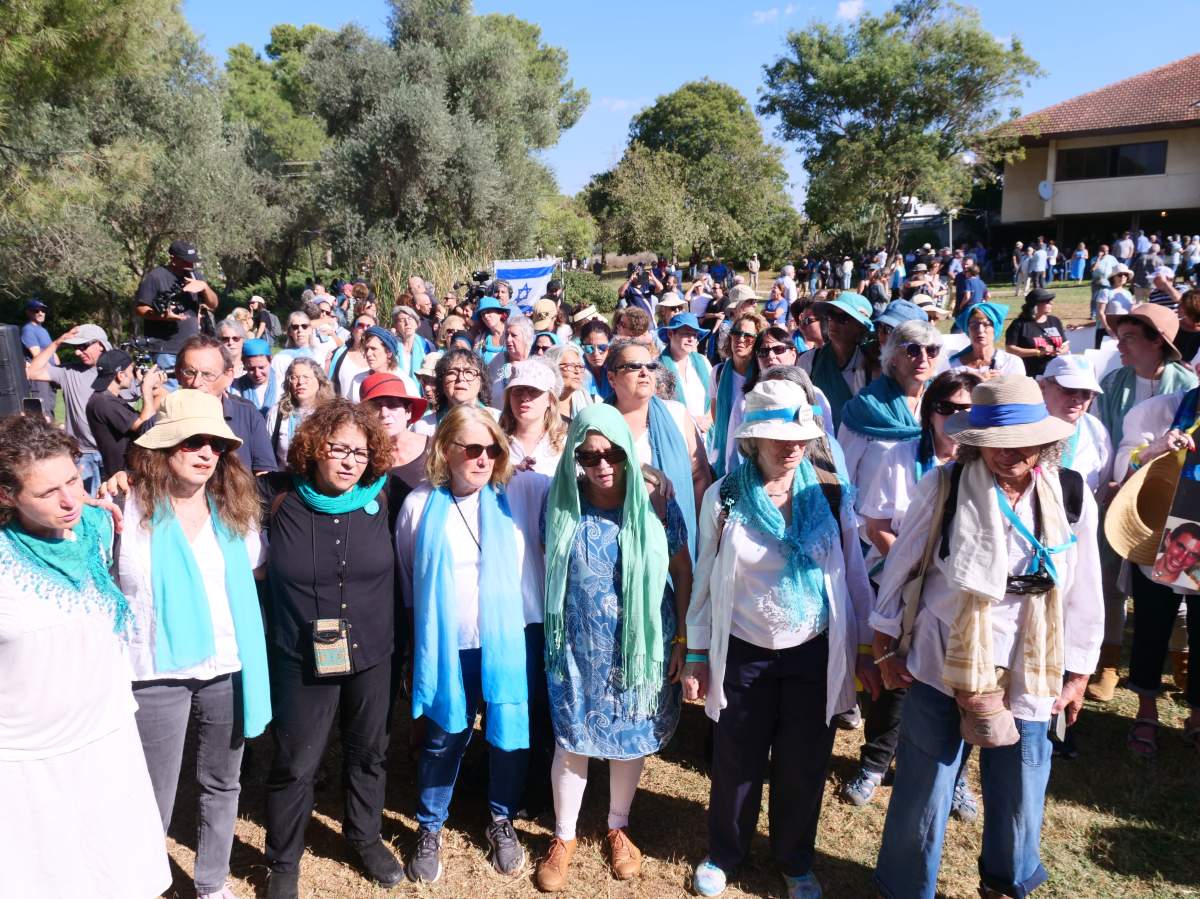 Women wear white shirts and blue scarves at the funeral of Israeli Canadian peace advocate Vivian Silver on Nov. 16, 2023. The outfit is commonly worn by members of the group Silver helped found and run, Women Wage Peace.