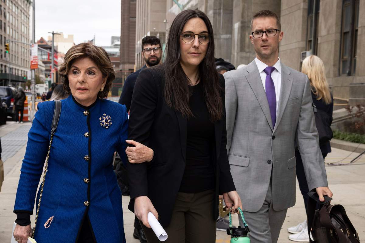 Kelsey Harbert, center, sexual assault victim of Cuba Gooding Jr., and her lawyer Gloria Allred, left, leave Manhattan Criminal Court, Thursday, Oct. 13, 2022, in New York