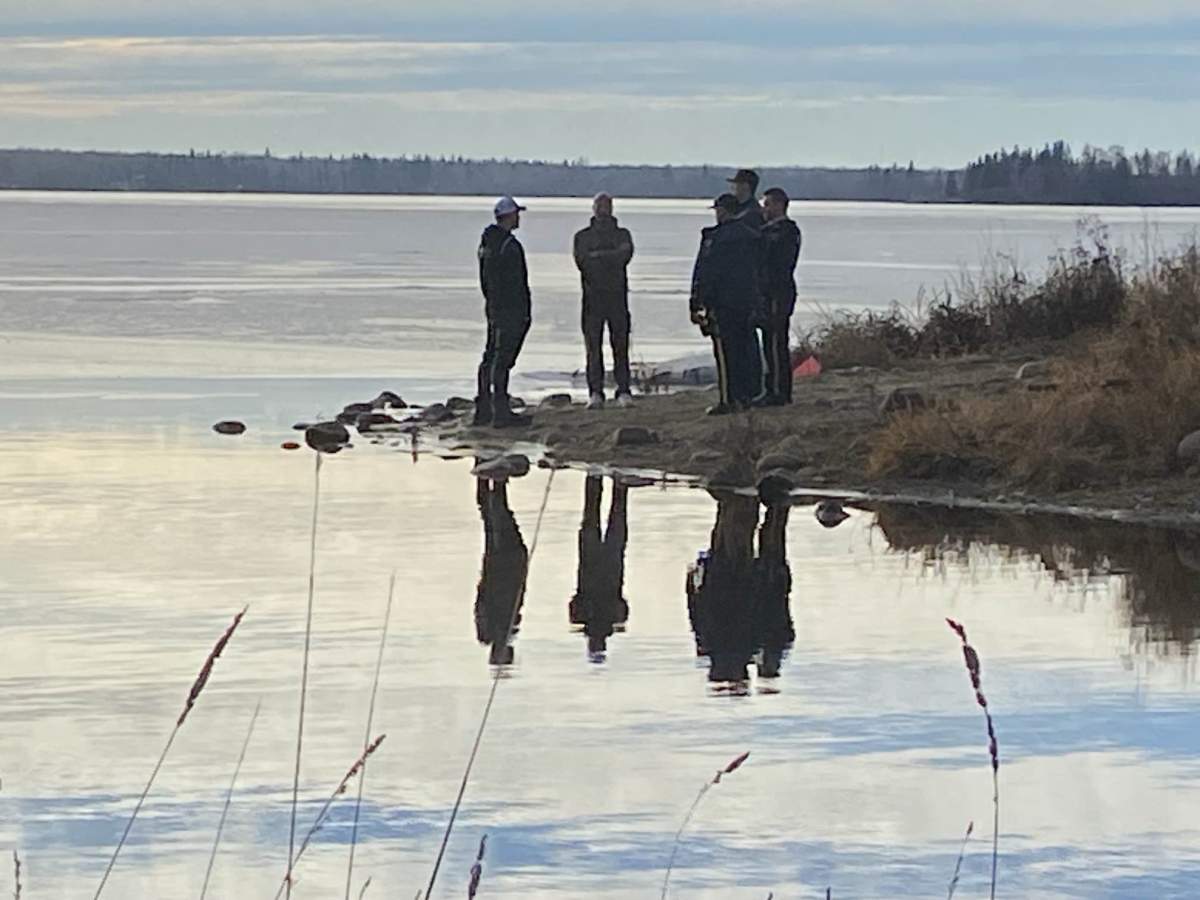 RCMP and dive teams search Lac Ste. Anne, Alta., for a missing family on Dec. 26, 2023.