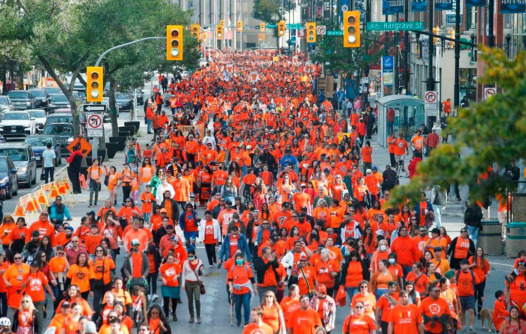 People attend the second annual Orange Shirt Day Survivors Walk in Winnipeg on Sept. 30, 2022.