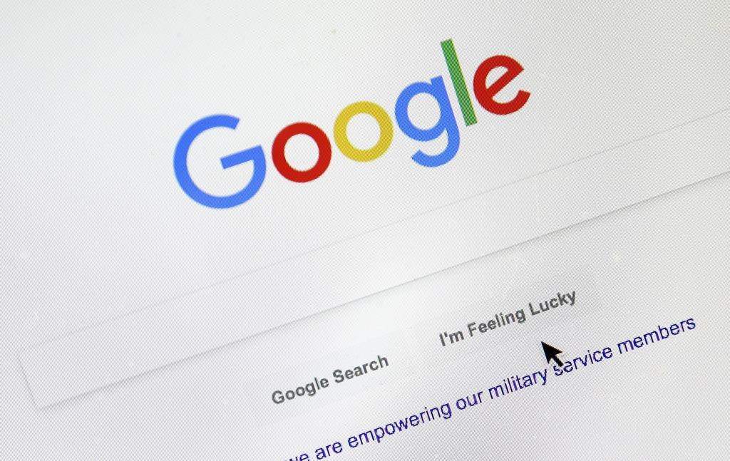 FILE - A cursor moves over Google's search engine page, in Portland, Ore., on Aug. 28, 2018. (AP Photo/Don Ryan, File).