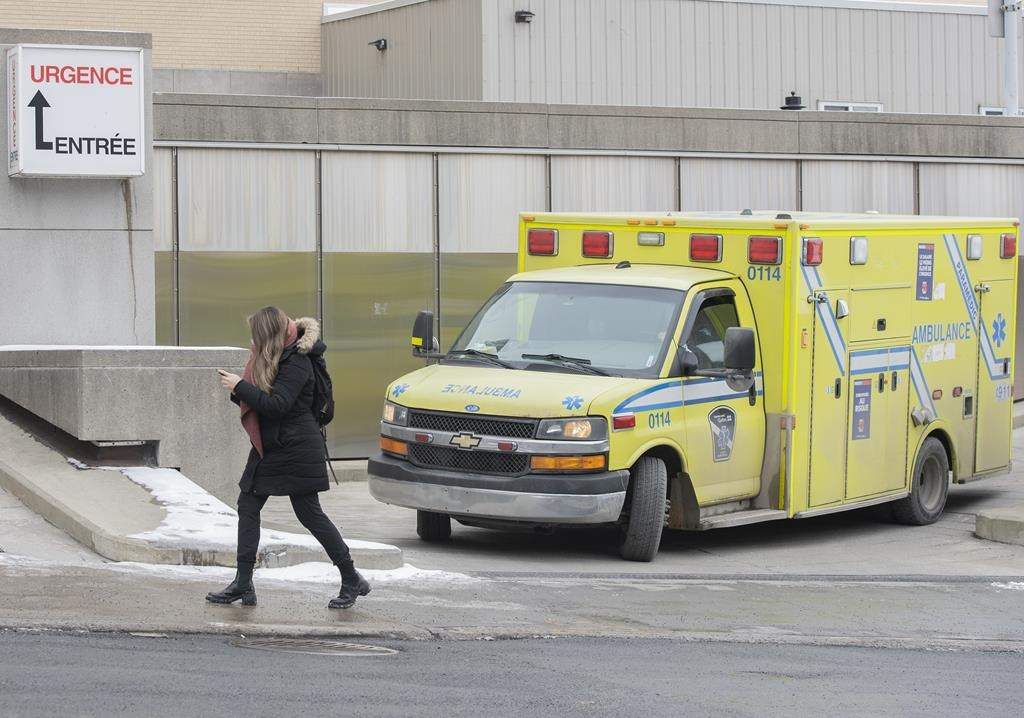 Emergency room doctors in Quebec say overcrowding in their departments has become critical and risks impacting patient health. An ambulance pulls out of the emergency entrance of a hospital in Montreal, Wednesday, Dec. 29, 2021. THE CANADIAN PRESS/Graham Hughes.