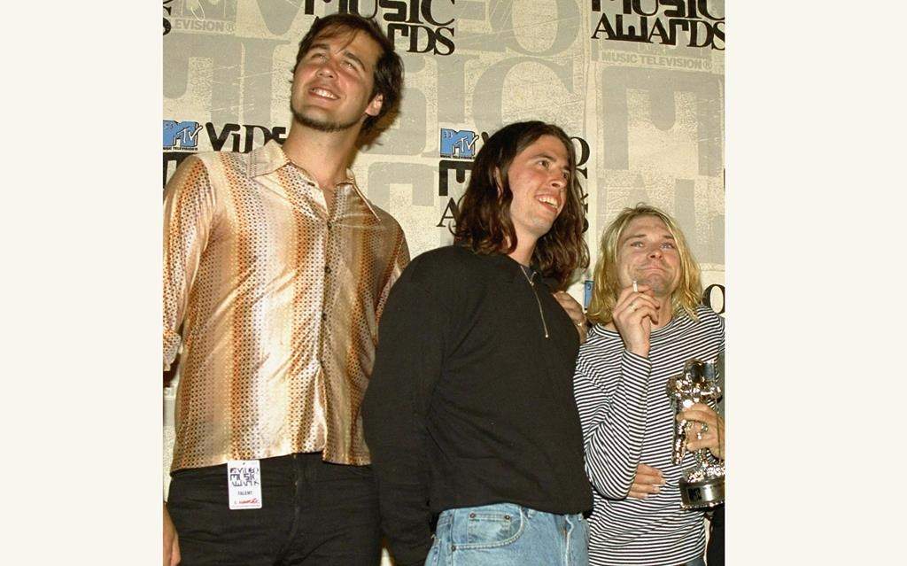 Nirvana band members Krist Novoselic, from left, Dave Grohl and Kurt Cobain pose after receiving the award for best alternative video for "In Bloom" at the 10th annual MTV Video Music Awards on Sept. 2, 1993. A federal appeals court has revived a child sexual exploitation lawsuit filed by the man who appeared naked as a 4-month-old infant on the 1991 cover of Nirvana's album 'Nevermind.'