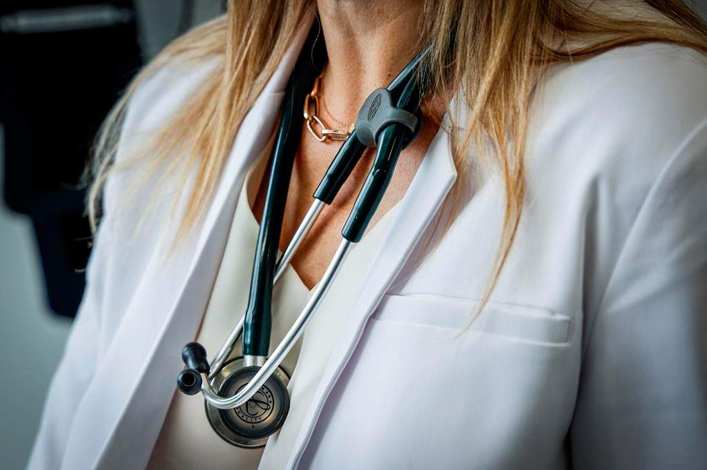 A doctor wearing a lab coat and stethoscope.
