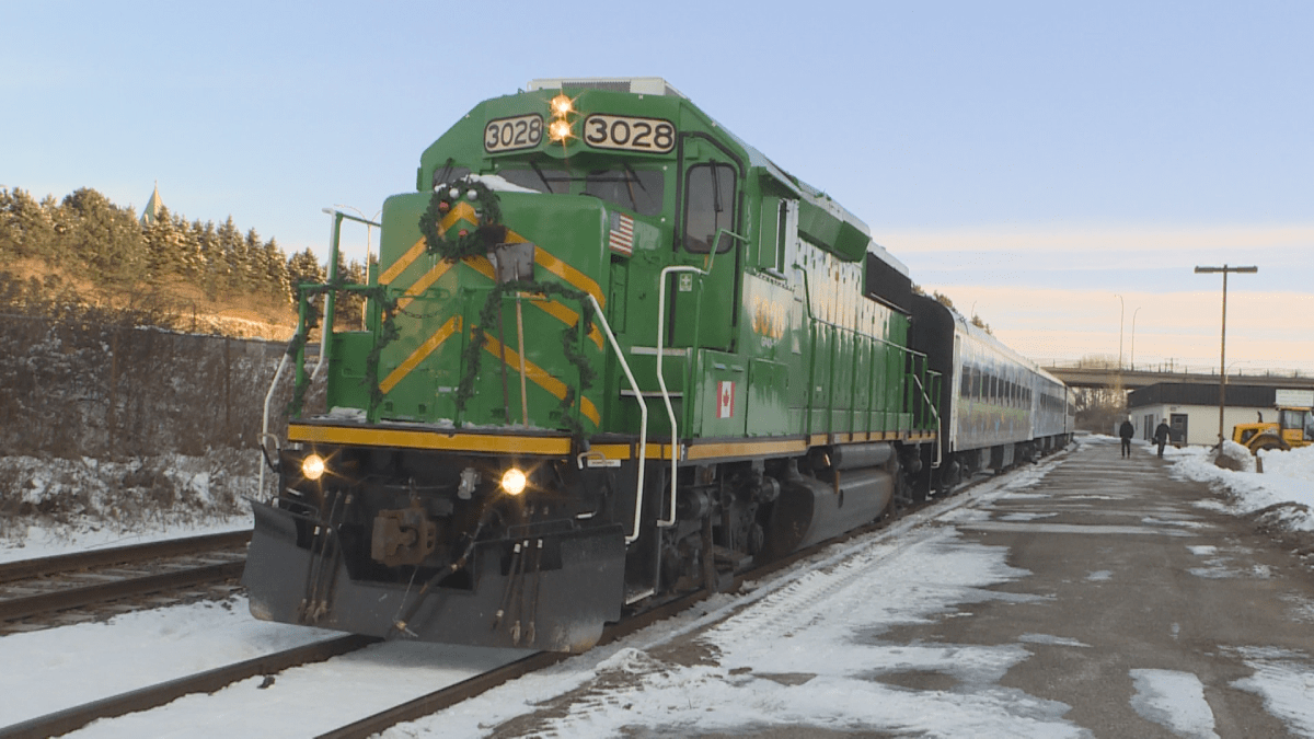 A green train with a wreath on the end.