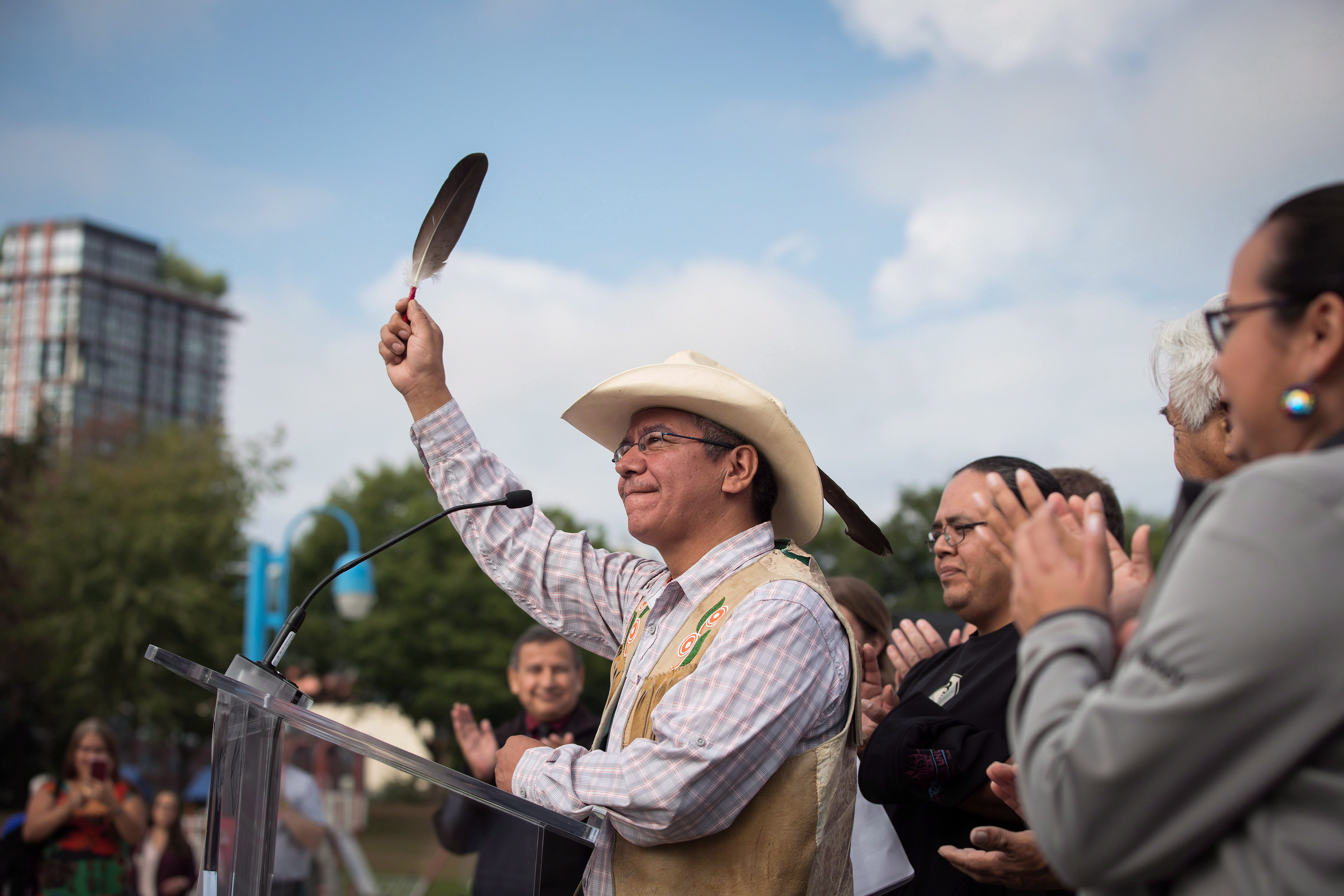 Coldwater Indian band Chief Lee Spahan raises an eagle feather after responding to a Federal Court of Appeal ruling on the Kinder Morgan Trans Mountain Pipeline expansion, during a news conference in Vancouver, on Thursday August 30, 2018. In a unanimous decision by a panel of three judges, the court says the National Energy Board's review of the project was so flawed that the federal government could not rely on it as a basis for its decision to approve the expansion.