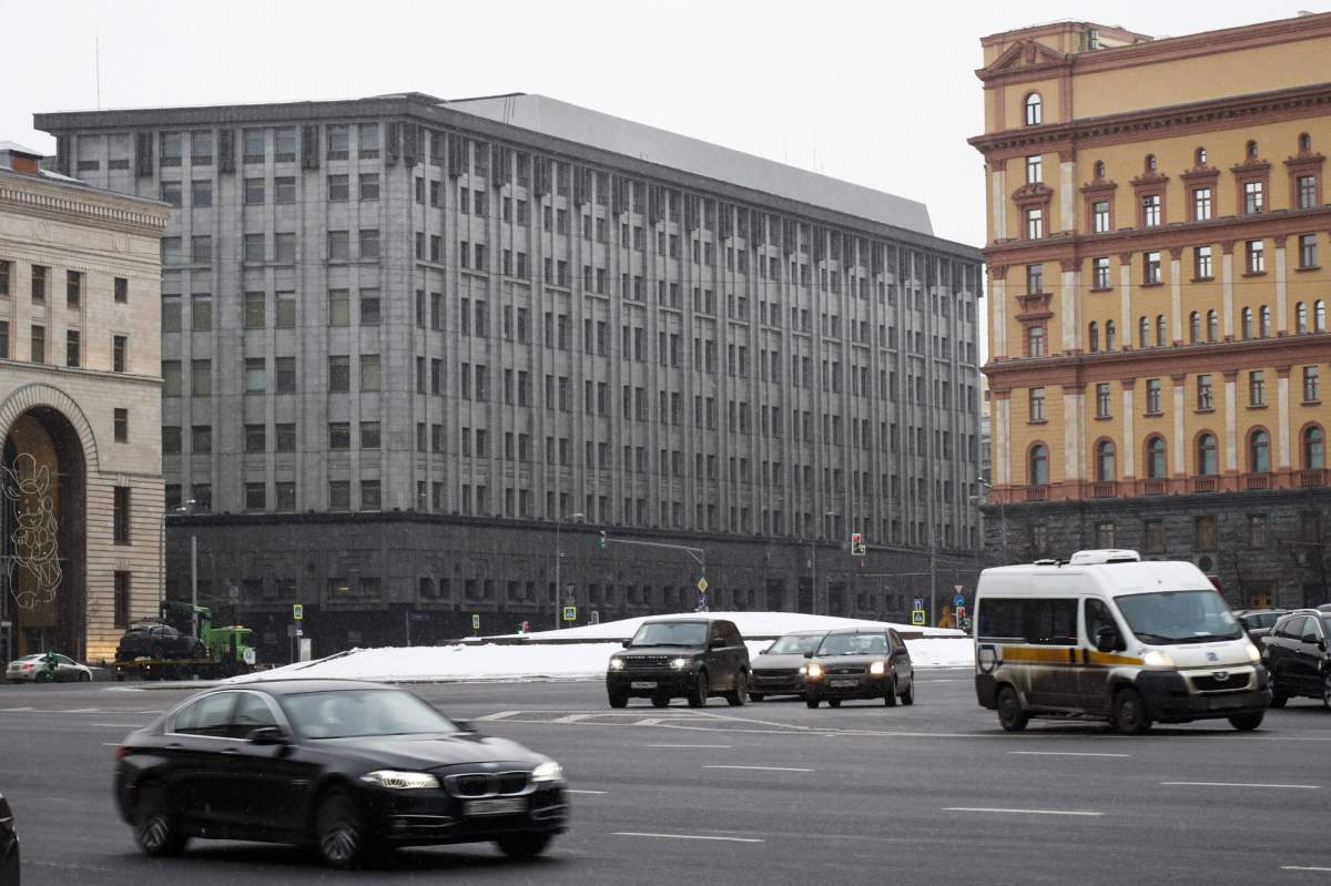 FILE – In this Friday, Dec. 30, 2016 file cars pass the FSB headquarters in downtown Moscow, Russia. A U.S. indictment of a Russian intelligence agent and an alleged hacker accused of using “spear-phishing” attacks with spam email accounts to target politicians and other groups and individuals in the U.S. and U.K. has shone a spotlight on the intertwining of the Russian security services and the murky digital underworld. (AP Photo/Alexander Zemlianichenko, file)