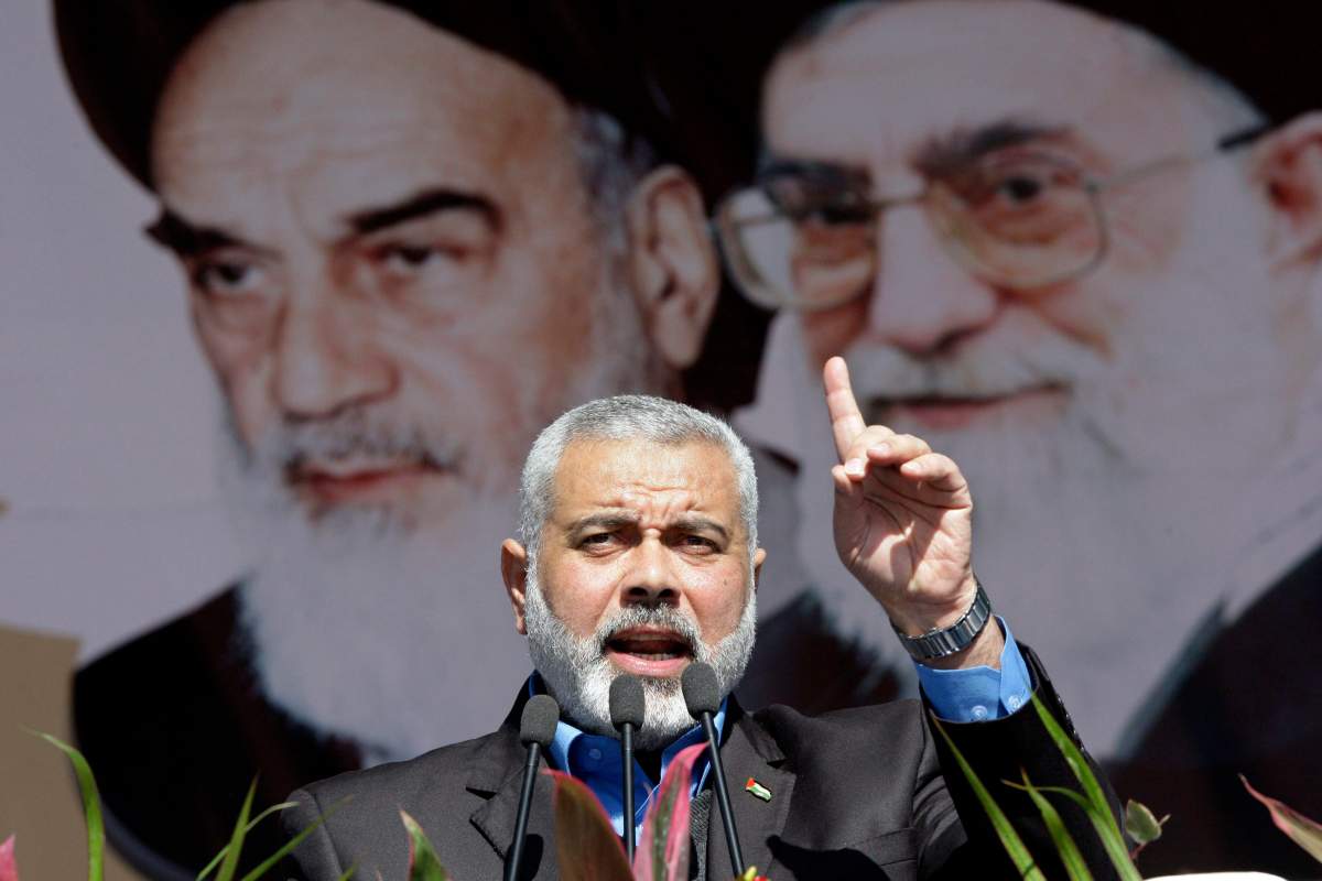 Leader of Hamas terrorist group, Ismail Haniyeh, speaks in front of portraits of Iran’s supreme leader Ayatollah Ali Khamenei, in Tehran, Feb. 11, 2012. (AP Photo/Vahid Salemi)