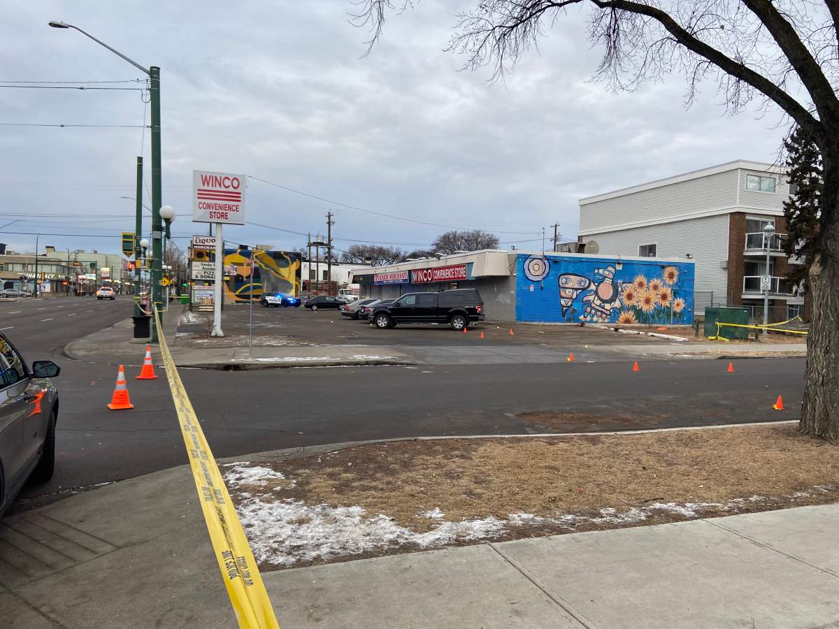 Police tape surrounds the parking lot outside a convenience store near 104 Street and 107 Avenue.