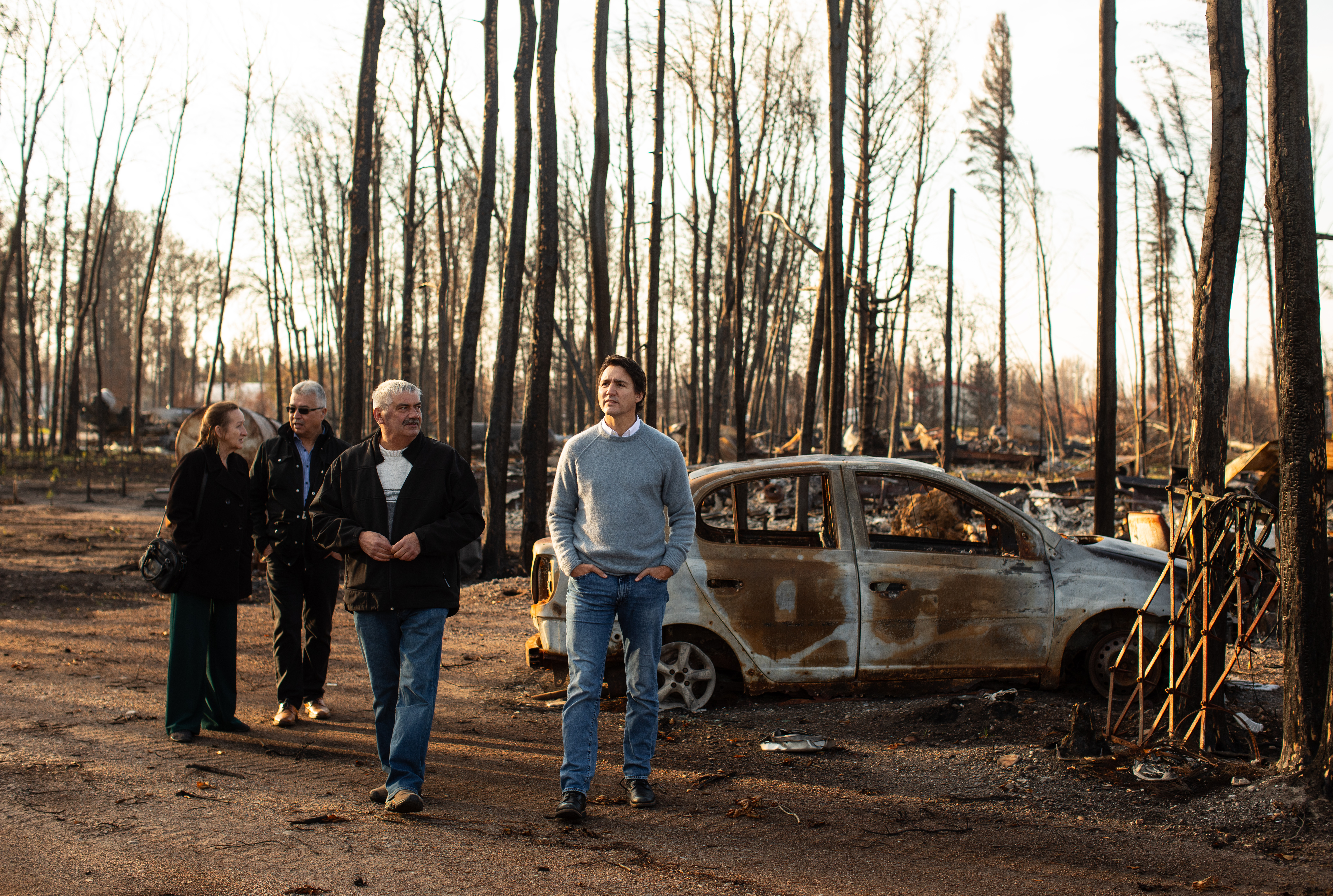 Northwest Territories Premier Caroline Cochrane, left to right, N.W.T. MP Micheal McLeod, Mayor of Enterprise Mike St. Amour and Prime Minister Justin Trudeau tour the wildfire damage in Enterprise, Northwest Territories.